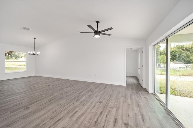 9731 Bahia Rd, Ocala, FL 34472 - unfurnished living room with lofted ceiling, a chandelier, healthy amount of natural light, wood finished floors, and a ceiling fan
