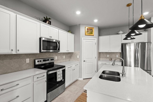9459 SW 52nd Loop, Ocala, FL 34481 - kitchen with appliances with stainless steel finishes, white cabinets, hanging light fixtures, recessed lighting, and decorative backsplash