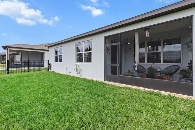 9459 SW 52nd Loop, Ocala, FL 34481 - rear view of house with stucco siding and a sunroom