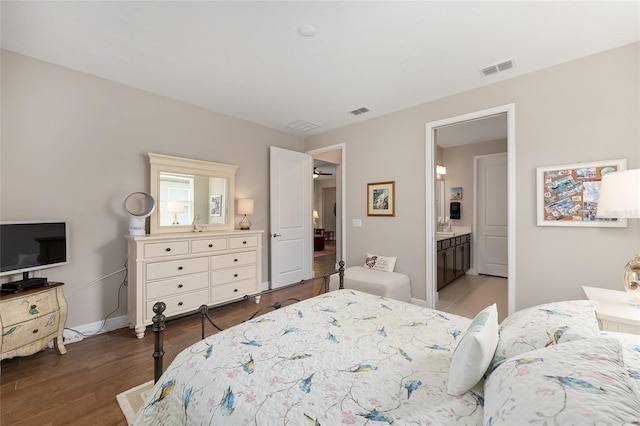 8820 SW 58th Street Rd, Ocala, FL 34481 - bedroom featuring baseboards, wood finished floors, and ensuite bathroom