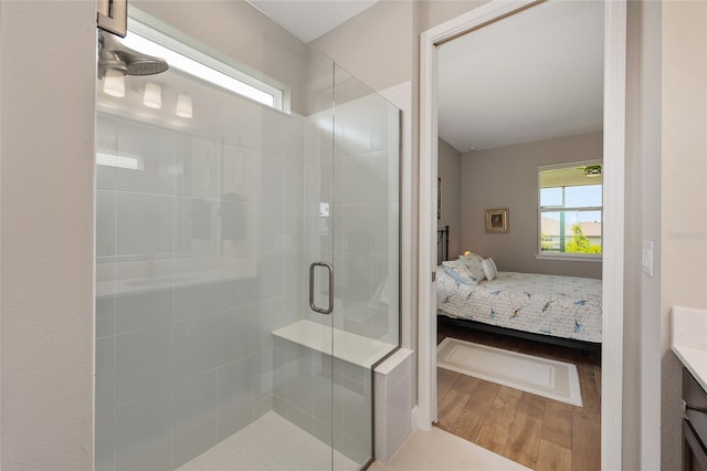 8820 SW 58th Street Rd, Ocala, FL 34481 - ensuite bathroom with plenty of natural light, a shower stall, and wood finished floors