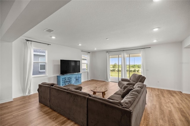 7199 SW 60th Ln, Ocala, FL 34474 - living room featuring light wood-style flooring, recessed lighting, a textured ceiling, and baseboards