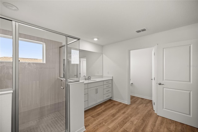7199 SW 60th Ln, Ocala, FL 34474 - bathroom featuring wood finished floors, vanity, a stall shower, and baseboards