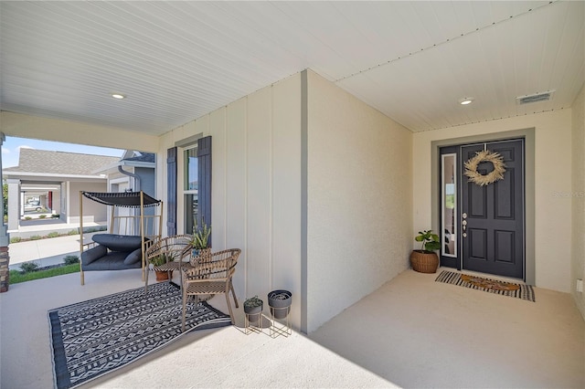 7199 SW 60th Ln, Ocala, FL 34474 - property entrance with covered porch and stucco siding