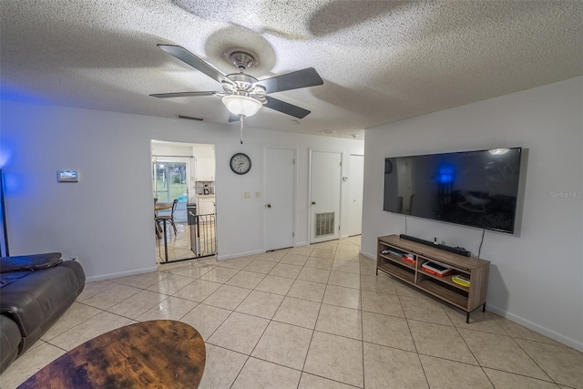 2140 NE 40th St, Ocala, FL 34479 - living room featuring ceiling fan, baseboards, light tile patterned floors, and a textured ceiling