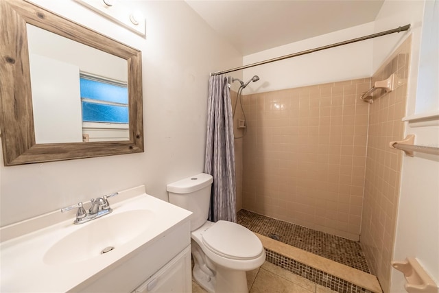 2140 NE 40th St, Ocala, FL 34479 - bathroom featuring tiled shower, toilet, vanity, and tile patterned flooring