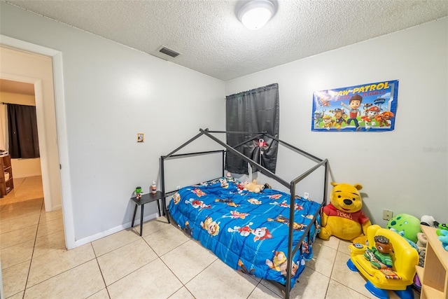 2140 NE 40th St, Ocala, FL 34479 - bedroom with a textured ceiling, tile patterned floors, and baseboards