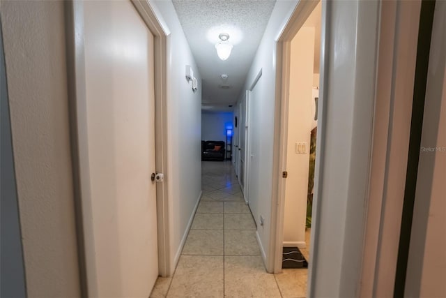2140 NE 40th St, Ocala, FL 34479 - hall featuring light tile patterned floors and a textured ceiling