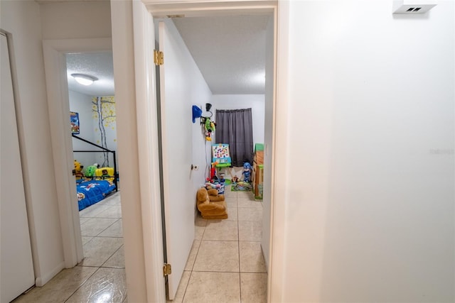 2140 NE 40th St, Ocala, FL 34479 - hallway with a textured ceiling and light tile patterned floors