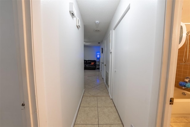 2140 NE 40th St, Ocala, FL 34479 - hall with light tile patterned floors and a textured ceiling