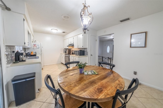 2140 NE 40th St, Ocala, FL 34479 - dining room with light tile patterned flooring and baseboards