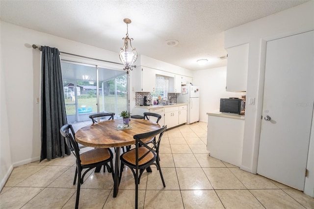 2140 NE 40th St, Ocala, FL 34479 - dining space with light tile patterned flooring and a textured ceiling