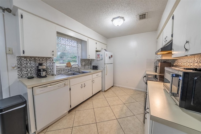 2140 NE 40th St, Ocala, FL 34479 - kitchen featuring white appliances, under cabinet range hood, a sink, light countertops, and backsplash