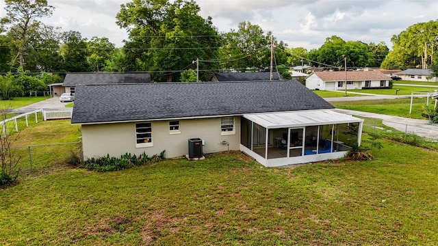 2140 NE 40th St, Ocala, FL 34479 - rear view of house featuring a sunroom, roof with shingles, and cooling unit