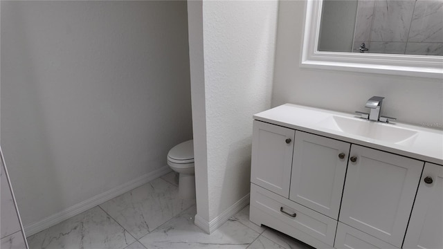 5323 NW 8th Pl, Ocala, FL 34482 - bathroom featuring marble look tiles, toilet, vanity, and baseboards