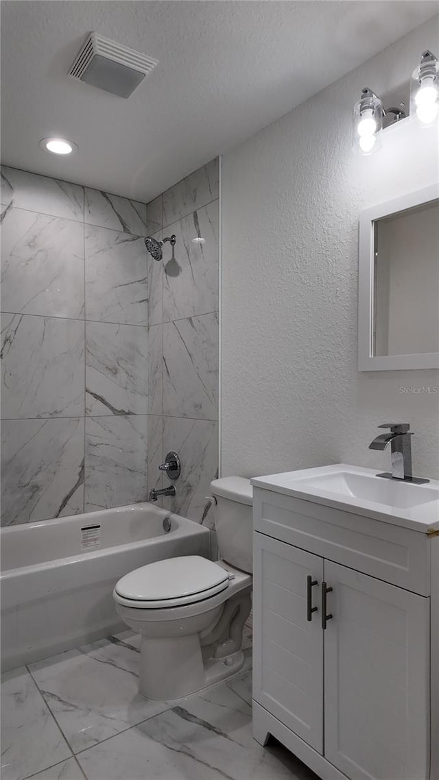 5323 NW 8th Pl, Ocala, FL 34482 - bathroom with marble look tile flooring, a textured wall, toilet, shower / tub combination, and vanity