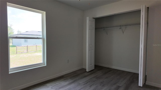 5323 NW 8th Pl, Ocala, FL 34482 - unfurnished bedroom with a closet, wood finished floors, and baseboards