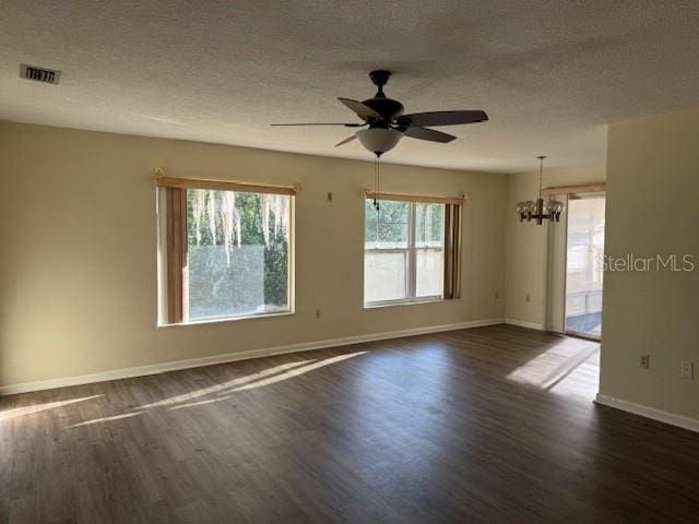 616 Water Rd, Ocala, FL 34472 - empty room featuring a chandelier, dark wood-type flooring, a ceiling fan, baseboards, and a textured ceiling