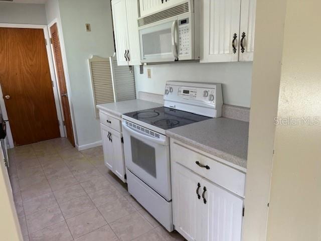616 Water Rd, Ocala, FL 34472 - kitchen featuring white appliances, light countertops, white cabinets, and light tile patterned floors