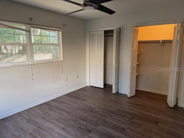 616 Water Rd, Ocala, FL 34472 - unfurnished bedroom featuring multiple closets, dark wood-style floors, baseboards, and a ceiling fan