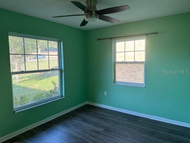 616 Water Rd, Ocala, FL 34472 - empty room featuring dark wood finished floors, healthy amount of natural light, and baseboards
