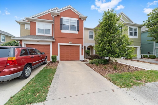 4927 SW 45th Cir, Ocala, FL 34474 - townhome / multi-family property with driveway, stucco siding, and a garage