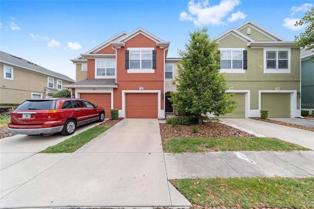 4927 SW 45th Cir, Ocala, FL 34474 - townhome / multi-family property with an attached garage, driveway, and stucco siding
