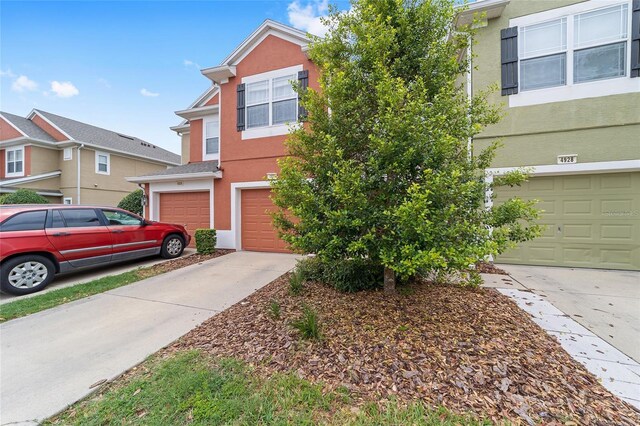 4927 SW 45th Cir, Ocala, FL 34474 - view of property featuring a garage, driveway, and stucco siding
