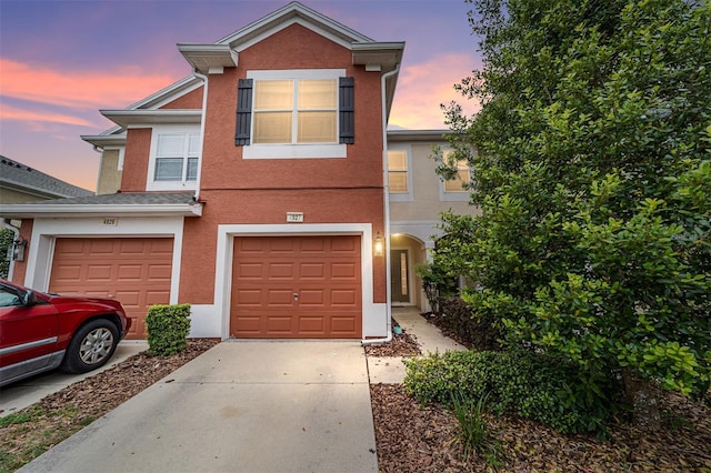 4927 SW 45th Cir, Ocala, FL 34474 - view of front of house with concrete driveway, stucco siding, and an attached garage