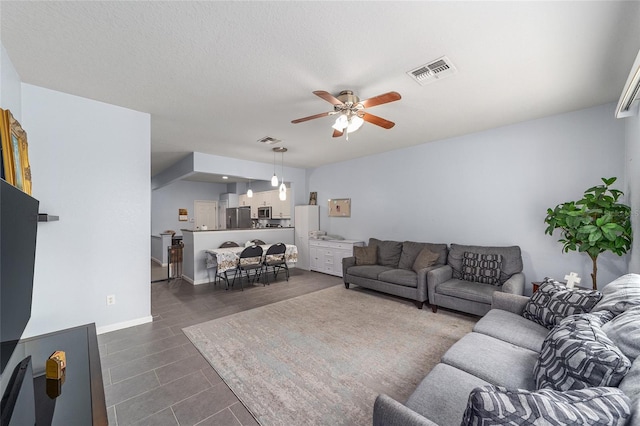 4927 SW 45th Cir, Ocala, FL 34474 - living room featuring a ceiling fan, dark tile patterned floors, and baseboards