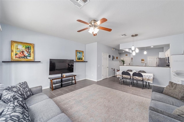 4927 SW 45th Cir, Ocala, FL 34474 - tiled living area with a ceiling fan and baseboards