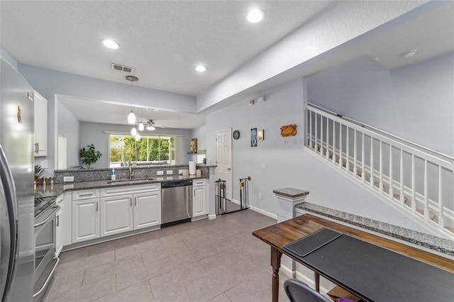 4927 SW 45th Cir, Ocala, FL 34474 - kitchen featuring appliances with stainless steel finishes, a sink, white cabinetry, pendant lighting, and recessed lighting