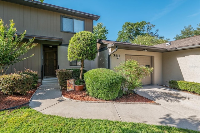 3815 NE 17th Street Cir, Ocala, FL 34470 - property entrance with an attached garage, concrete driveway, and stucco siding