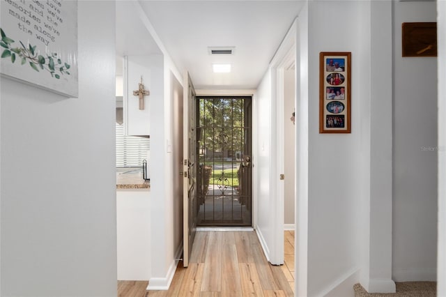 3815 NE 17th Street Cir, Ocala, FL 34470 - doorway to outside featuring light wood finished floors and baseboards