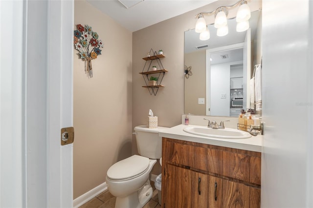 3815 NE 17th Street Cir, Ocala, FL 34470 - bathroom with toilet, vanity, baseboards, and tile patterned flooring
