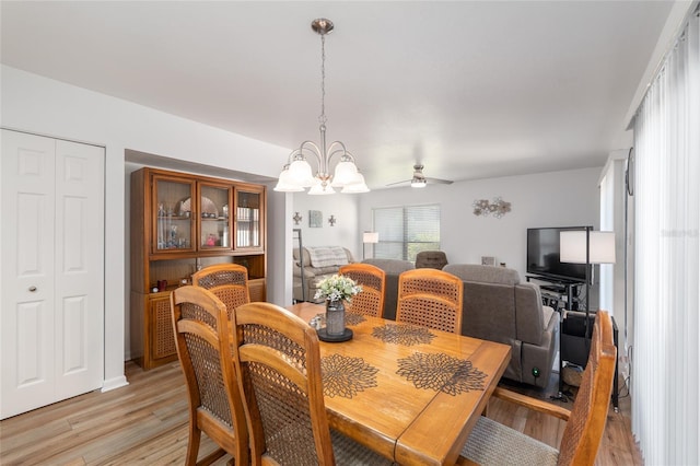 3815 NE 17th Street Cir, Ocala, FL 34470 - dining space featuring light wood-style floors, a ceiling fan, and a chandelier