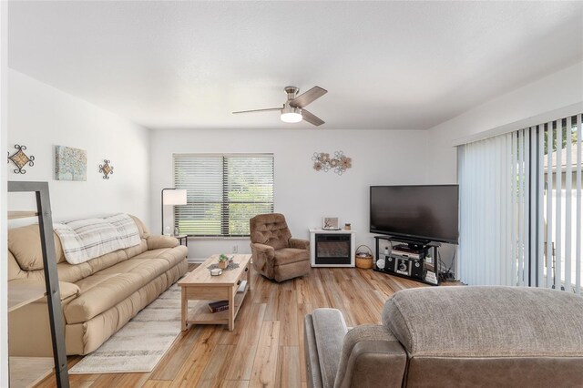 3815 NE 17th Street Cir, Ocala, FL 34470 - living area with plenty of natural light, a ceiling fan, and light wood finished floors