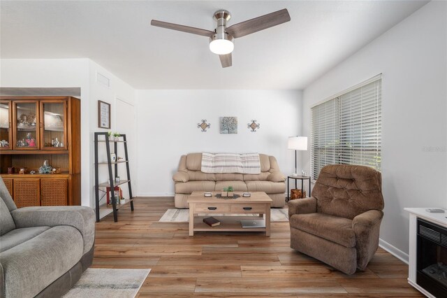 3815 NE 17th Street Cir, Ocala, FL 34470 - living area with ceiling fan, light wood-style floors, and baseboards