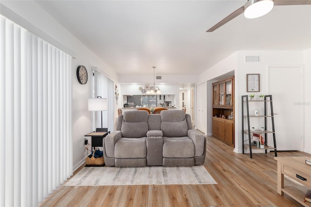 3815 NE 17th Street Cir, Ocala, FL 34470 - living room with light wood-style flooring, a chandelier, and a ceiling fan