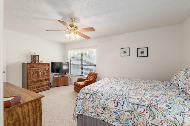 3815 NE 17th Street Cir, Ocala, FL 34470 - bedroom featuring light carpet, a textured ceiling, and a ceiling fan