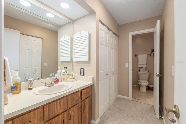 3815 NE 17th Street Cir, Ocala, FL 34470 - bathroom with a closet, toilet, vanity, recessed lighting, and baseboards