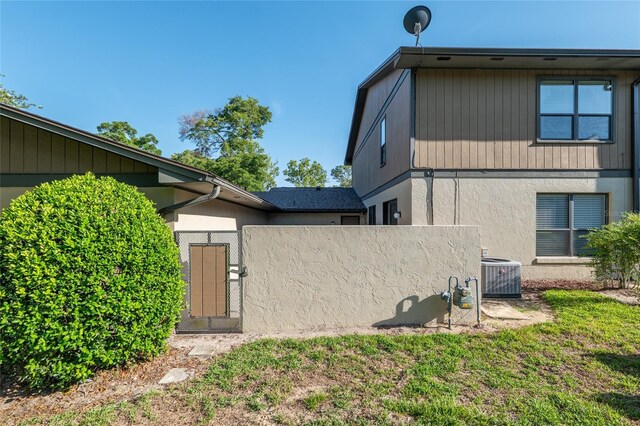3815 NE 17th Street Cir, Ocala, FL 34470 - view of home's exterior with central AC, stucco siding, and fence