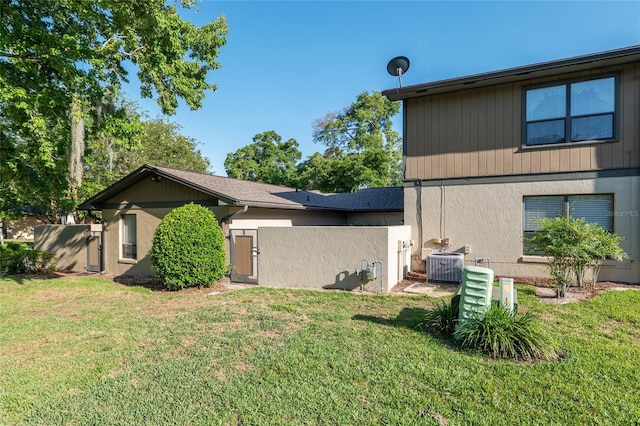 3815 NE 17th Street Cir, Ocala, FL 34470 - view of side of home featuring cooling unit and a yard