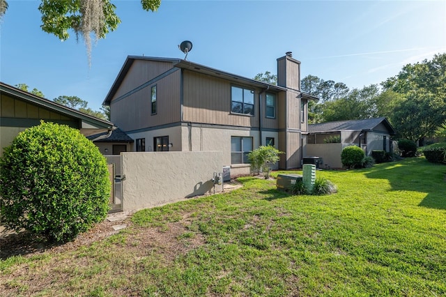 3815 NE 17th Street Cir, Ocala, FL 34470 - rear view of house featuring a chimney and central AC unit