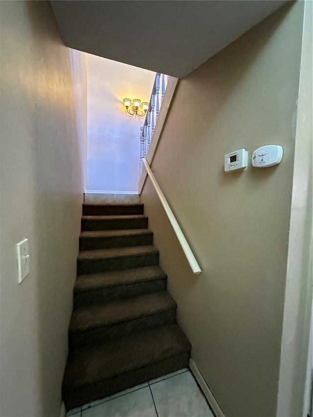 staircase featuring baseboards