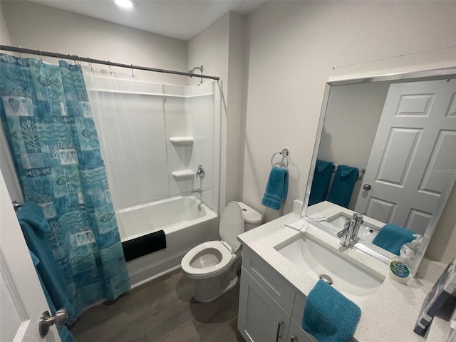 bathroom featuring toilet, vanity, shower / tub combo with curtain, and wood finished floors