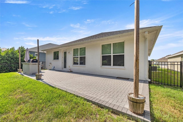 6557 SE 4th Ln, Ocala, FL 34472 - back of house featuring a patio, stucco siding, and roof with shingles