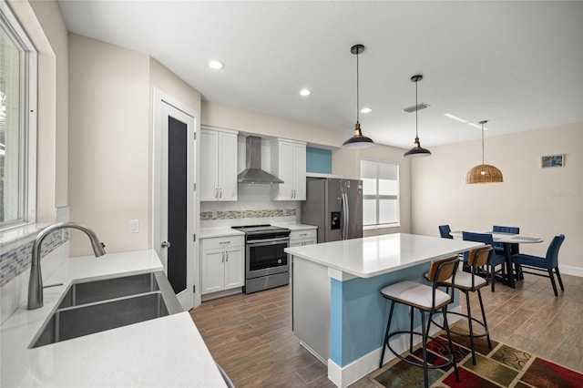 6557 SE 4th Ln, Ocala, FL 34472 - kitchen with stainless steel appliances, wall chimney range hood, a sink, tasteful backsplash, and dark wood finished floors