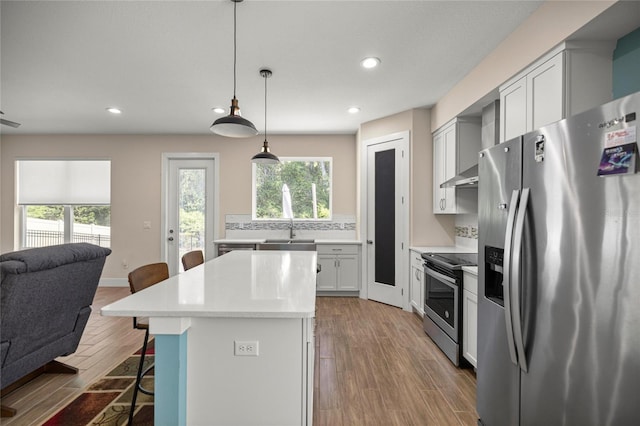 6557 SE 4th Ln, Ocala, FL 34472 - kitchen with stainless steel appliances, open floor plan, a breakfast bar, a center island, and recessed lighting