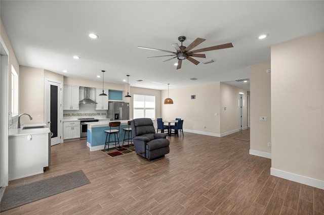 6557 SE 4th Ln, Ocala, FL 34472 - living room with ceiling fan, wood finished floors, baseboards, and recessed lighting
